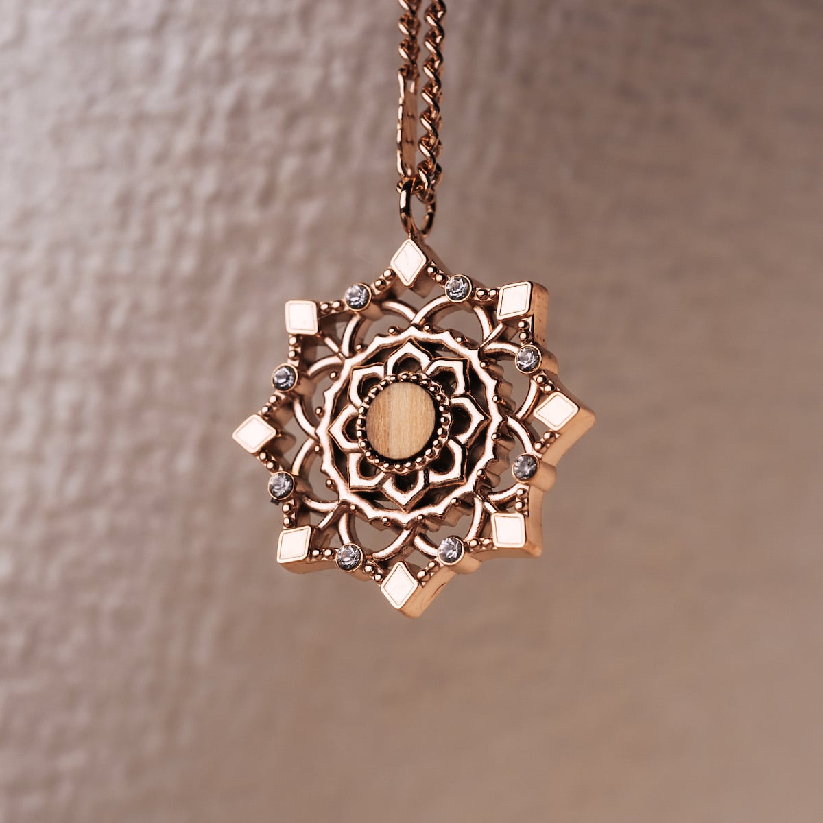 "Aphonia Necklace" - a rose gold necklace with intricate olive accents and elegant design.