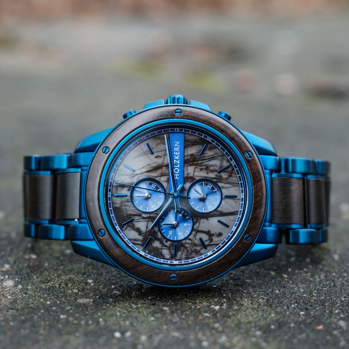 "Priamus" watch in maple and marble, featuring a striking blue design and intricate dial details.