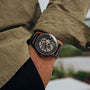 "Carbon" watch featuring a skeleton design in a sleek gray maple and dark gray style.