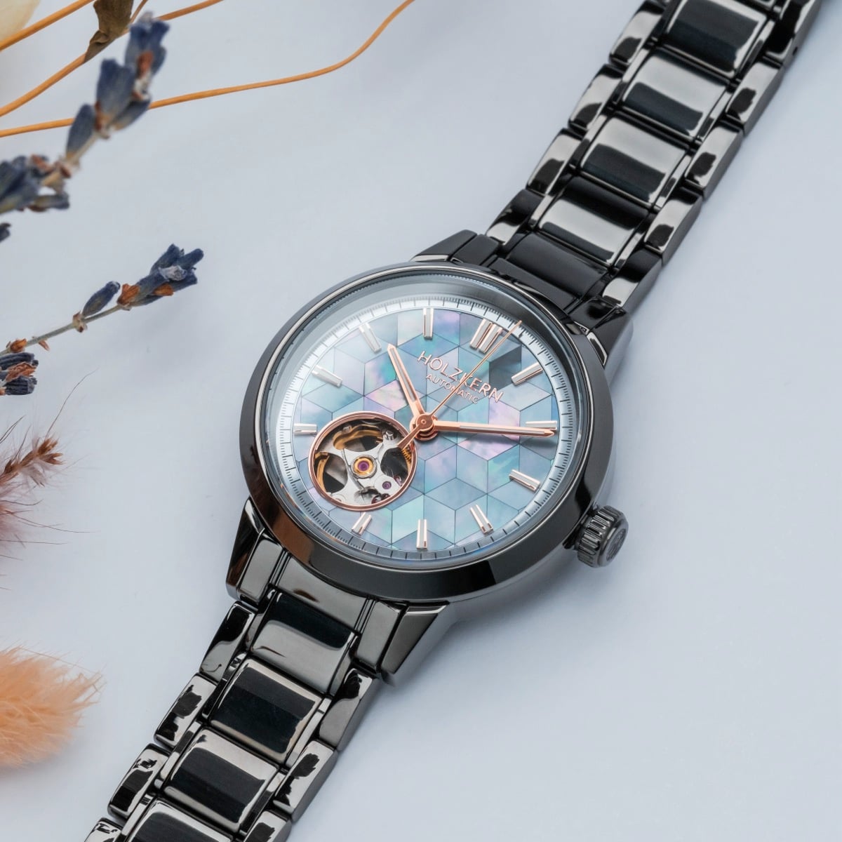 Mirrorance watch features a nacre ceramic face and sleek design, with a stylish metallic band.