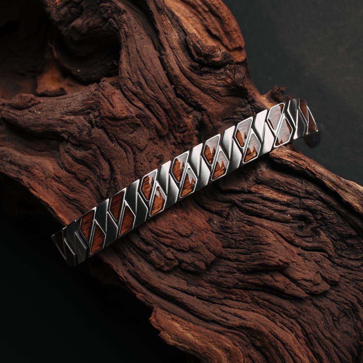 "Baritone" bracelet featuring a walnut and silver design on rustic wood.