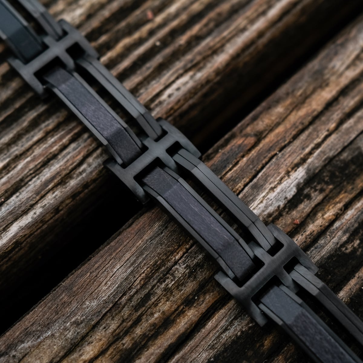 "Staccato" bracelet, featuring a sleek maple and black design on a textured wooden surface.