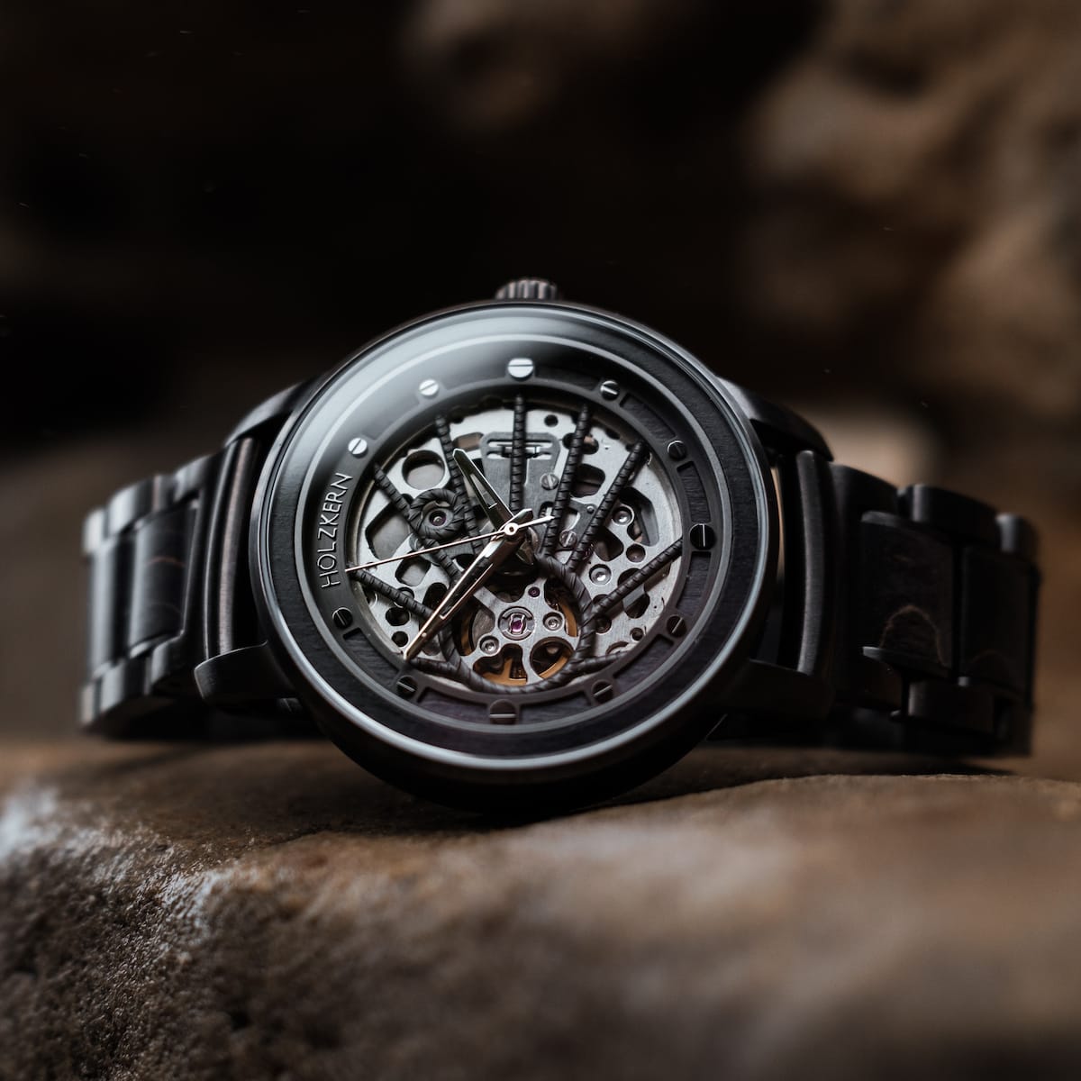 "Carbon" watch with a gray maple and dark gray design, featuring an intricate exposed mechanism.
