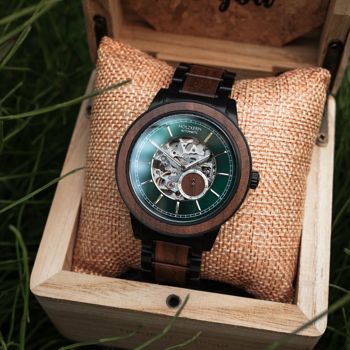 "Sigiriya" watch featuring a walnut case and intricate mechanical design in a rustic wooden box.
