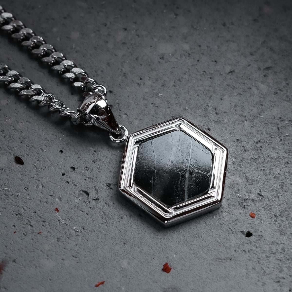 "Axis Necklace", a stylish hexagonal necklace with a marble pendant and silver chain.