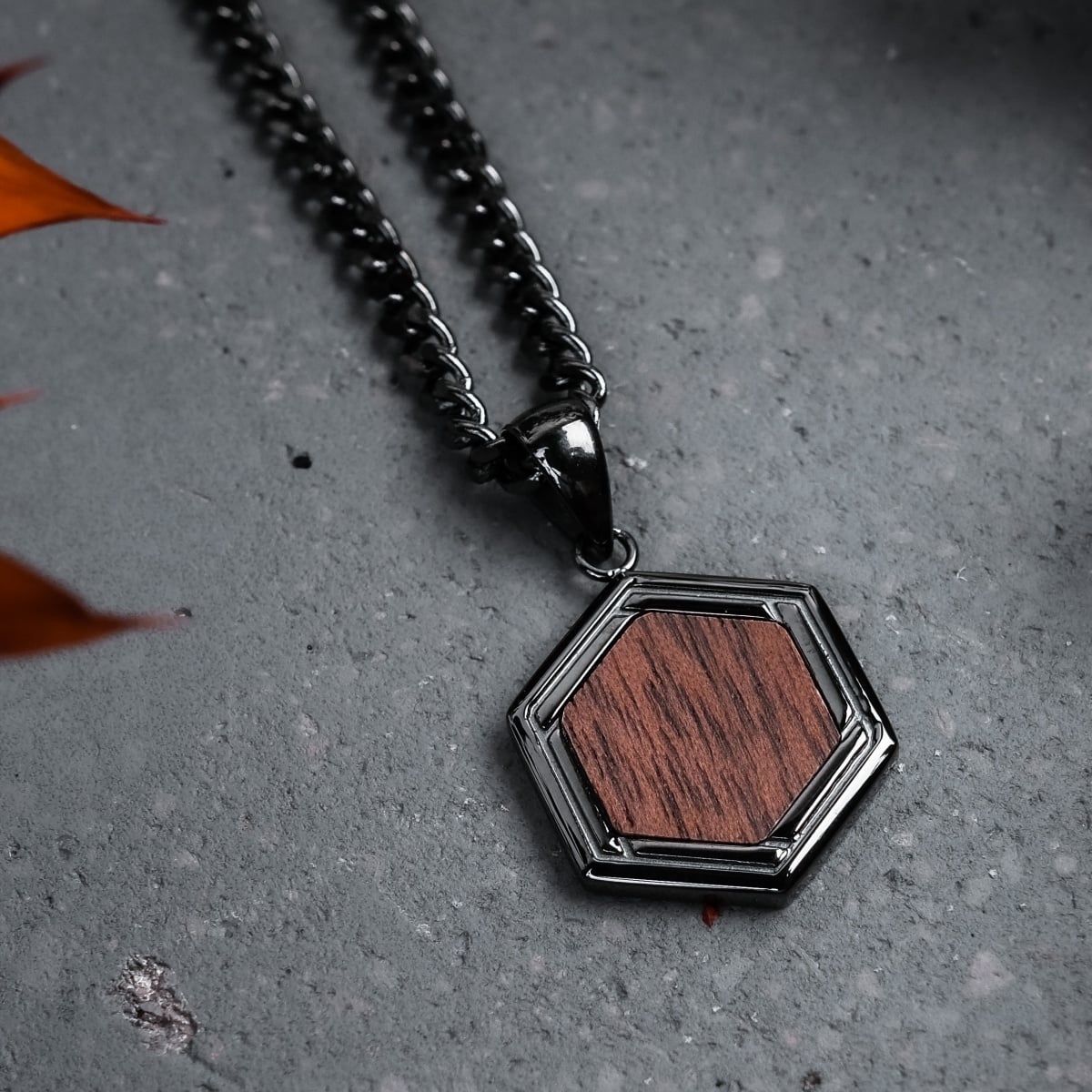 "Axis Necklace" necklace, featuring a hexagonal walnut and dark gray design.
