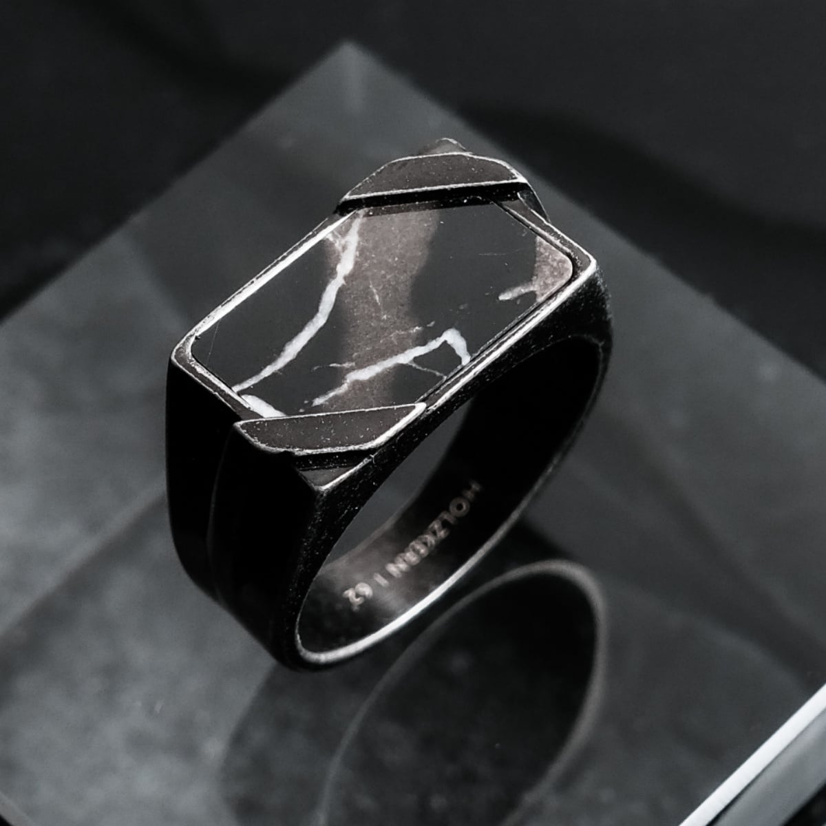 "Binomial Ring": a striking ring in marble and antique silver with a modern geometric design.