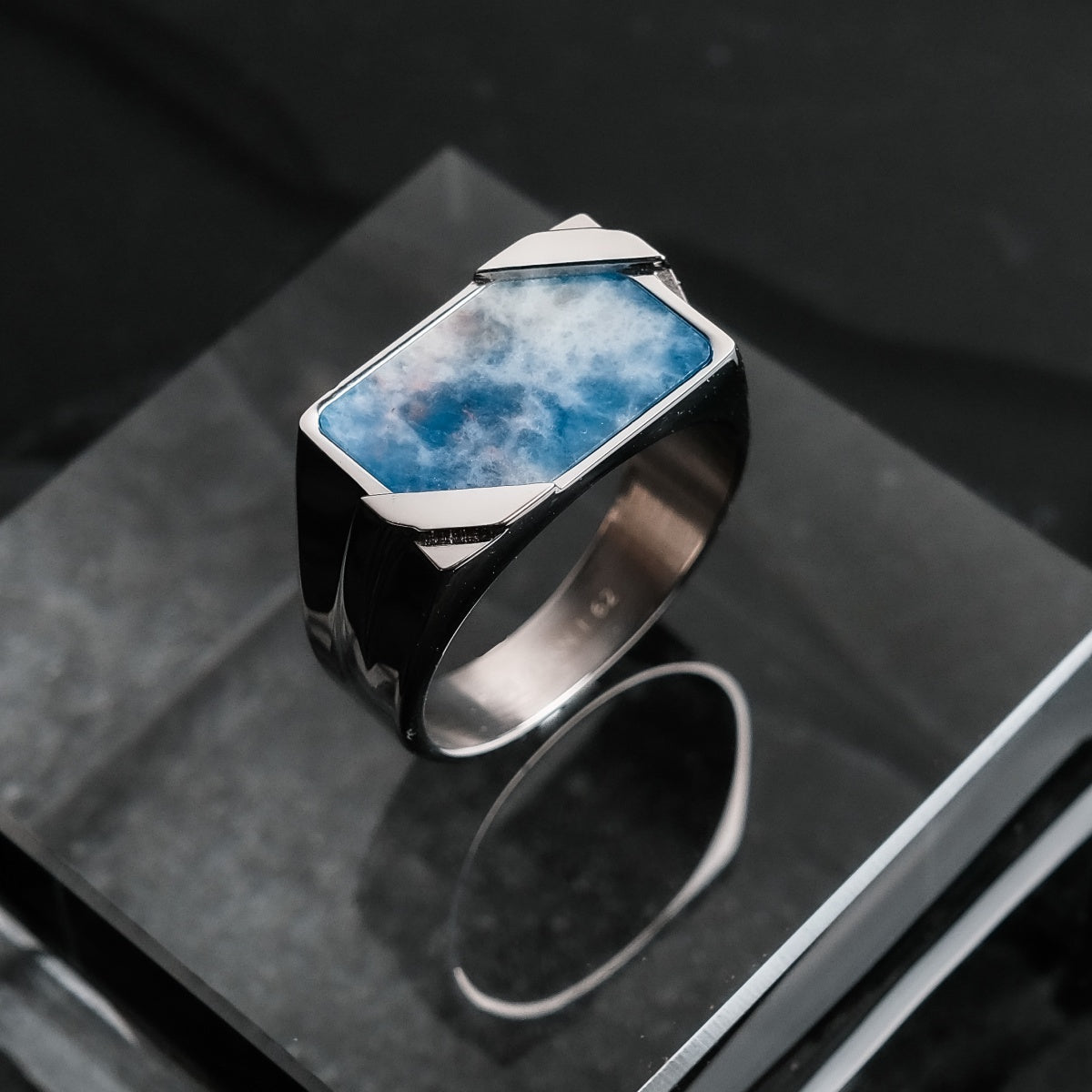 "Binomial Ring" ring featuring a geometric design with blue sodalite and silver elements on a modern band.