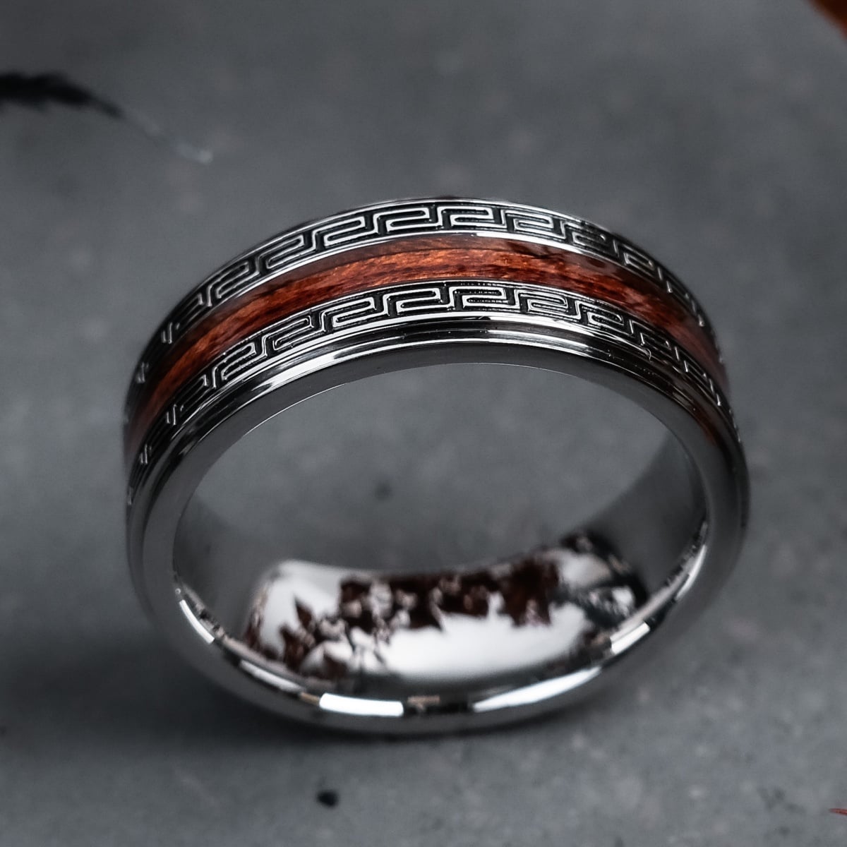 "Numerary Ring", a stylish ring with a blend of koa wood and silver, featuring intricate patterns and a modern design.