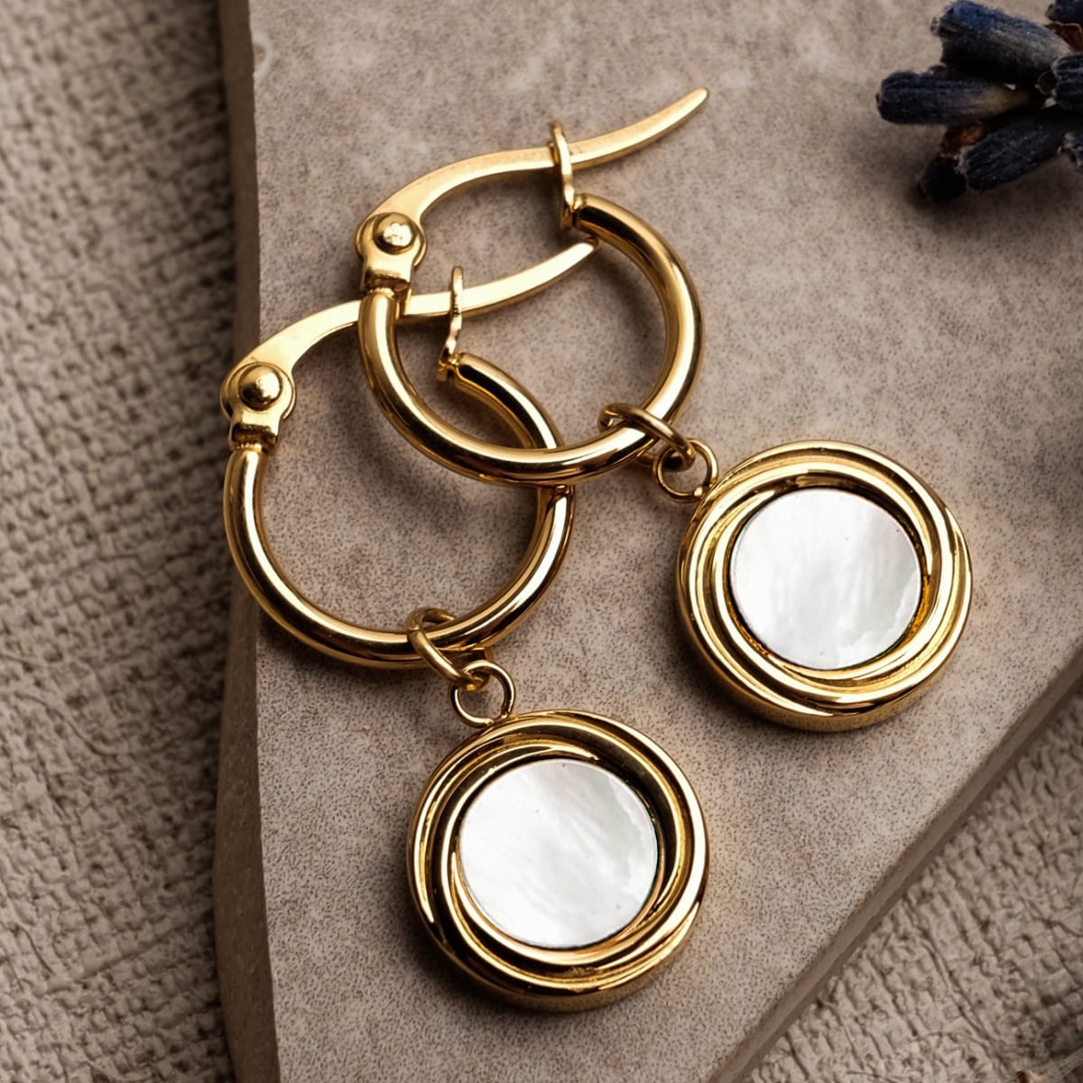 "Zendala Earrings": Elegant earrings featuring white nacre and gold accents.