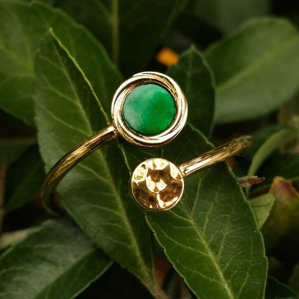"Zendala Ring" ring featuring a vibrant green nacre stone set in gold, showcasing an elegant and natural style.