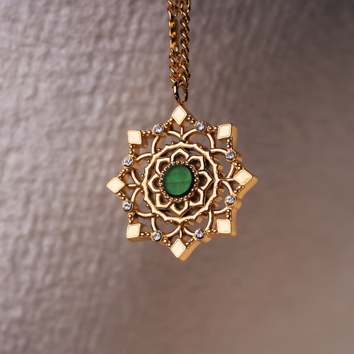 "Aphonia Necklace": intricate green marble and gold necklace with an ornate, elegant design.