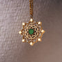 "Aphonia Necklace": intricate green marble and gold necklace with an ornate, elegant design.