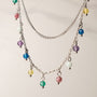 "Free Play Necklace", a vibrant necklace with rainbow beads and silver chains, offers a playful style.