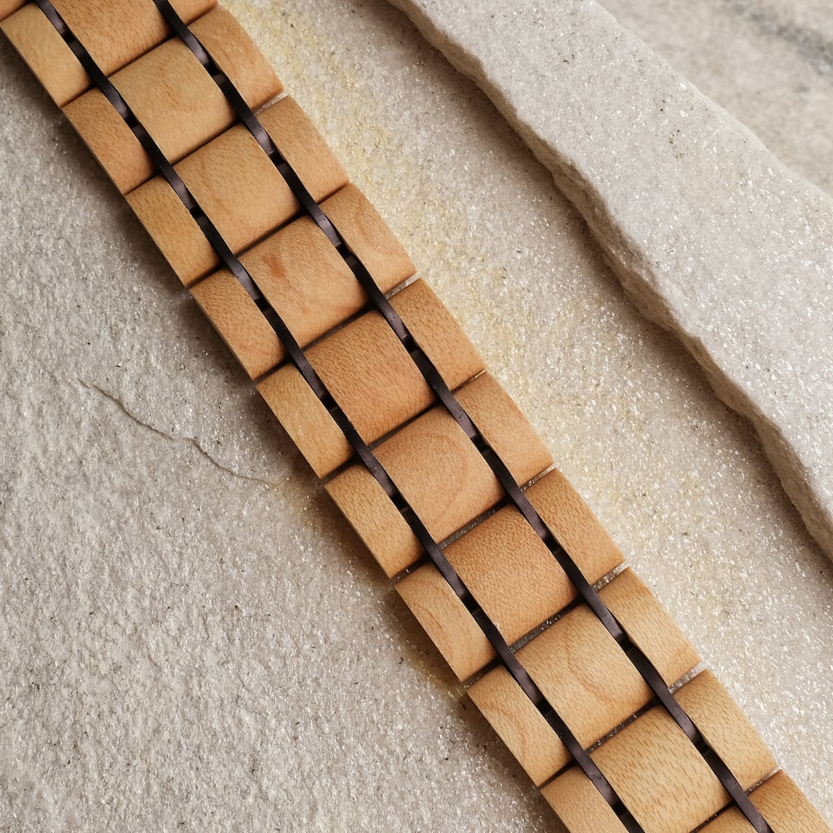 "Grandezza" watch strap featuring maple and dark purple design, showcasing a natural wood aesthetic.
