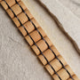 "Grandezza" watch strap featuring maple and dark purple design, showcasing a natural wood aesthetic.