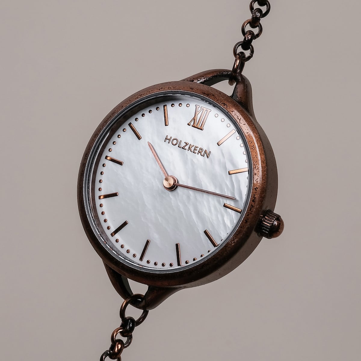 "Touching" watch featuring nacre face and antique copper finish with a classic, elegant style.