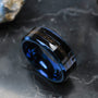 "Cartesian Ring", a stylish ring with a maple wood inlay and blue accents, set against a dark background.