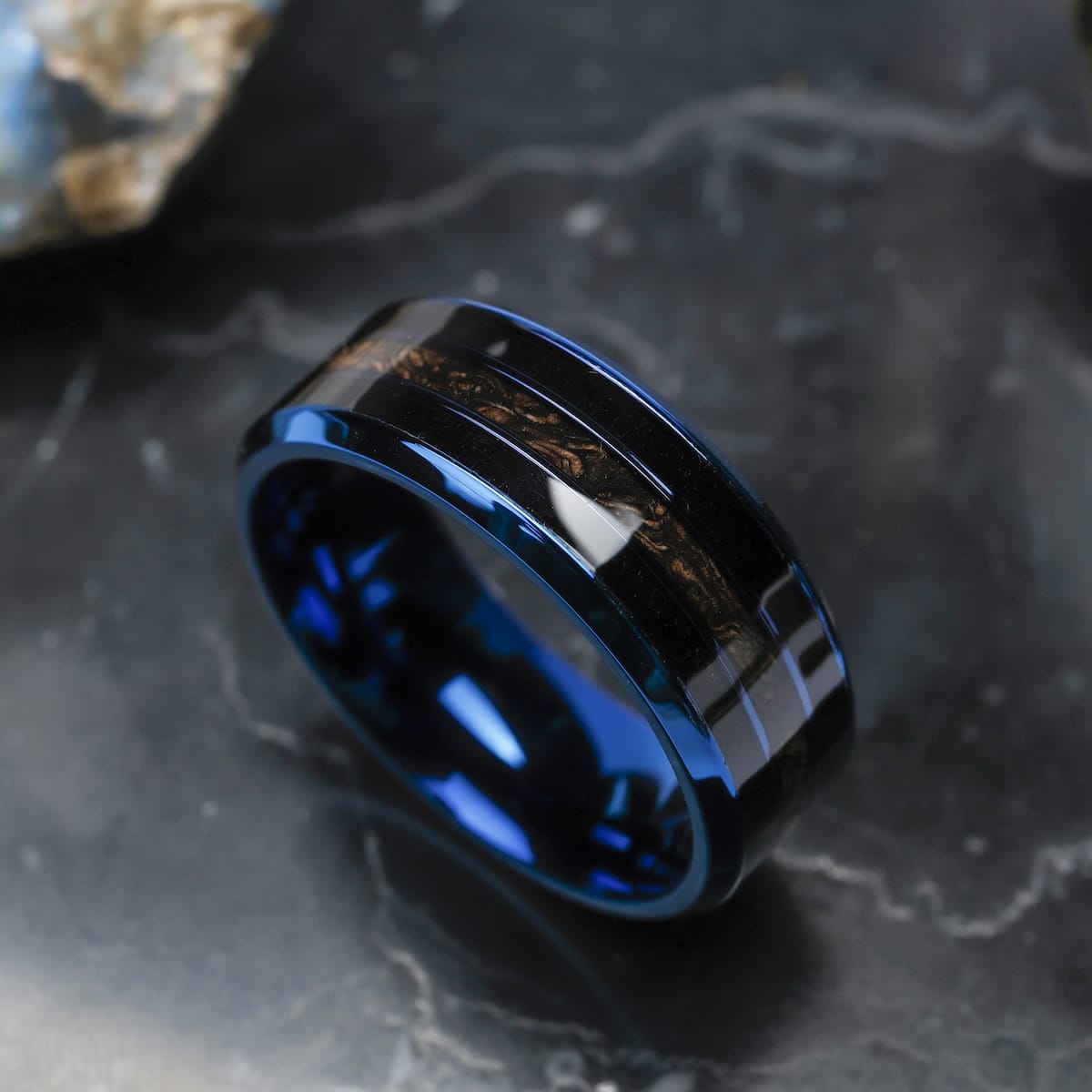 "Cartesian Ring", a stylish ring with a maple wood inlay and blue accents, set against a dark background.