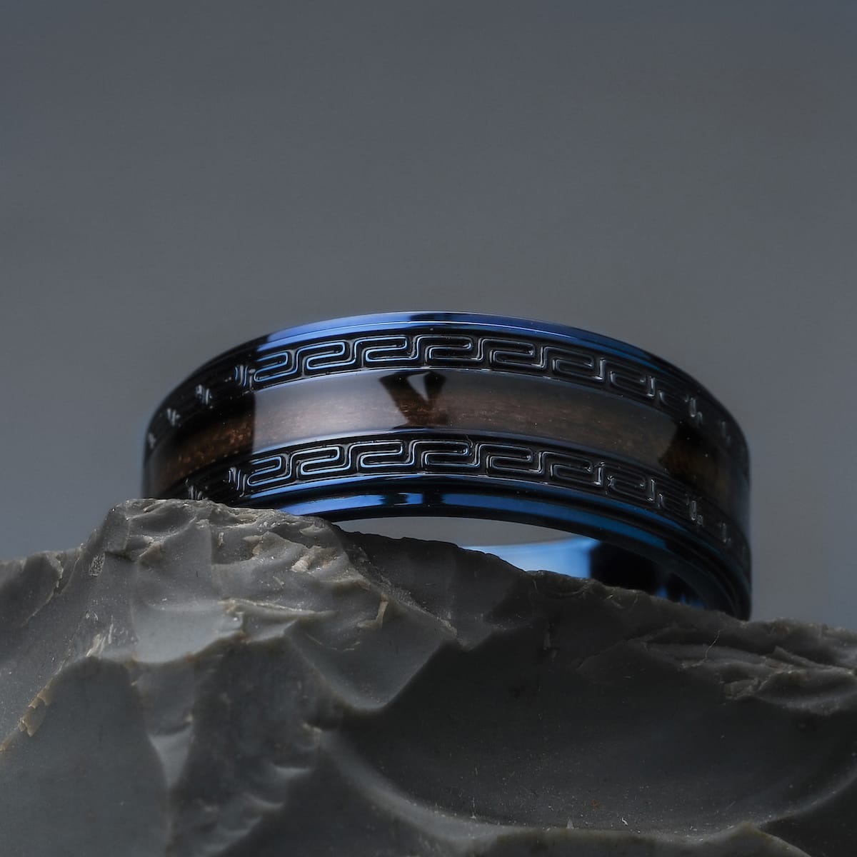 "Numerary Ring" ring, a stylish blend of walnut and blue, featuring a sleek and modern design.