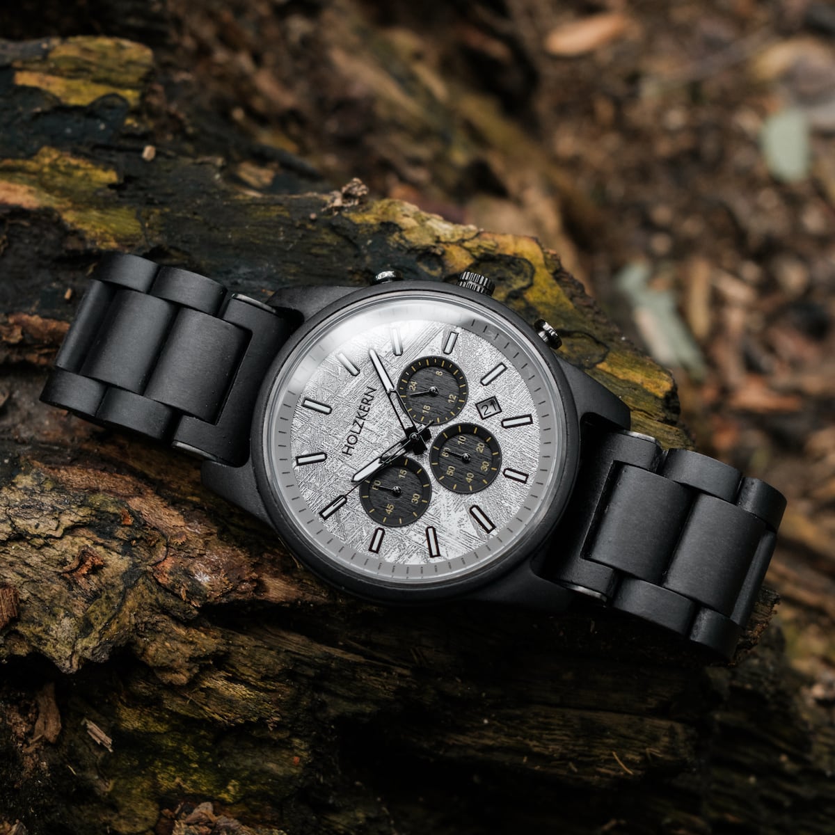"Northwall" watch in Maple/Rockgrey with a sleek, modern design placed on a rustic wood surface.
