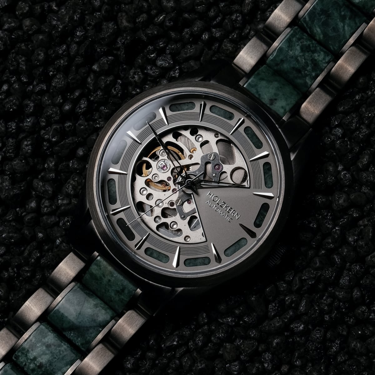 "Acraman", a watch featuring a marble band and dark gray dial with a skeleton design.