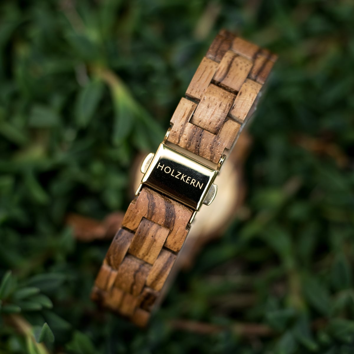 "Earth" watch featuring zebrawood and maple, showcasing a natural and elegant design against a leafy background.