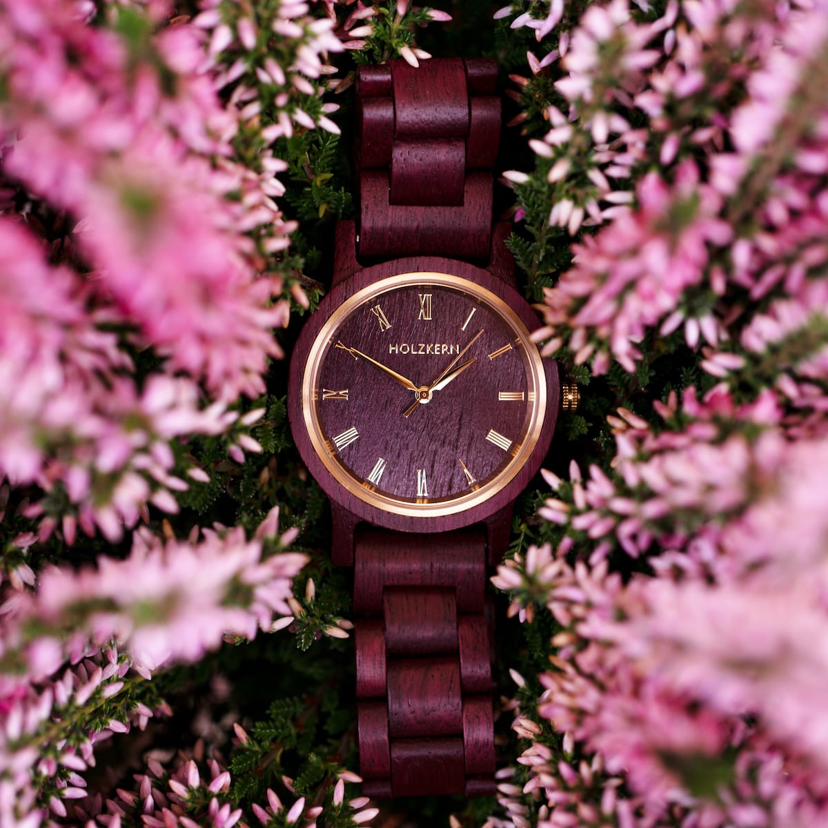 "Calm" wooden watch featuring an elegant amaranth design surrounded by pink flowers.