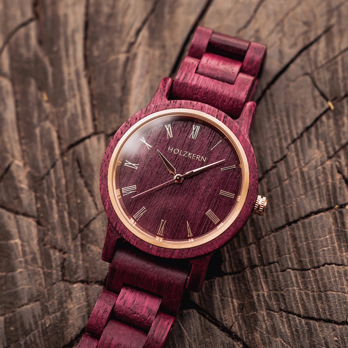 "Calm" wooden watch with an elegant amaranth finish on a rustic textured background.