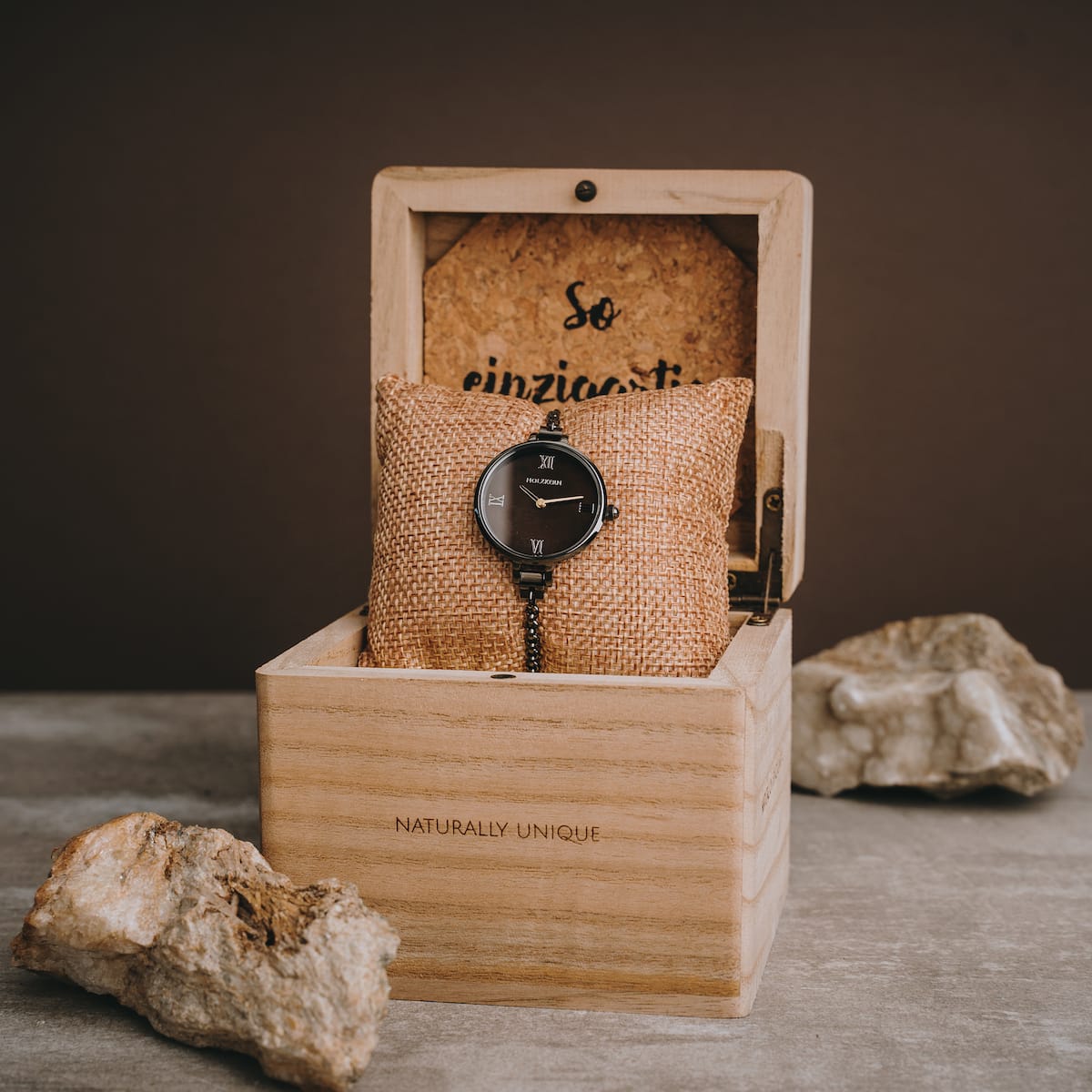 "Élisa" watch in nacre and dark gray, elegantly displayed in a wooden box.