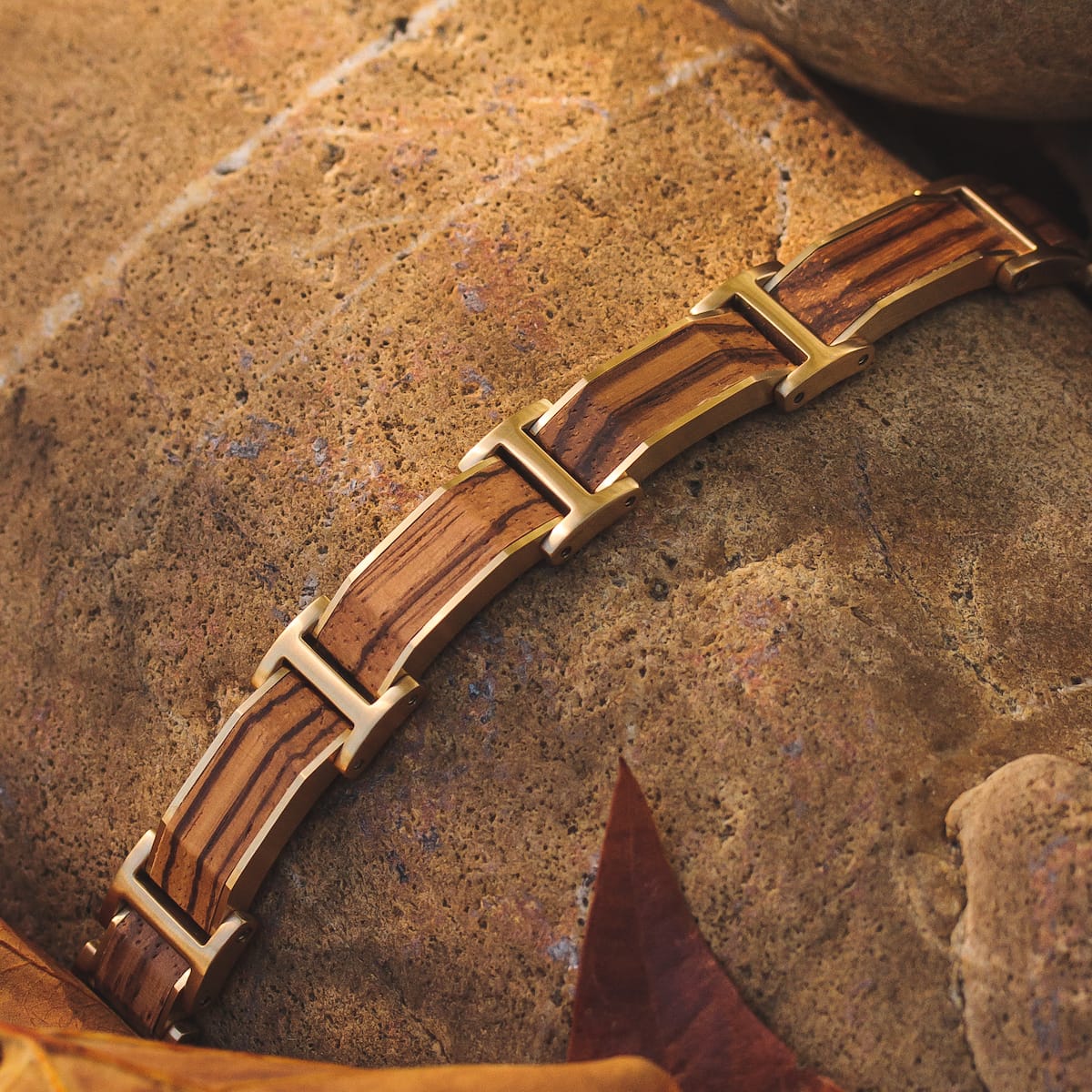 "Acapella" bracelet featuring zebrawood and gold with an elegant, natural style.