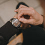 "Gaudí" watch, featuring a walnut and steel design with a sleek, modern style.