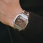 "Gaudí" watch featuring a walnut dial and stainless steel band, showcasing a modern and elegant design.