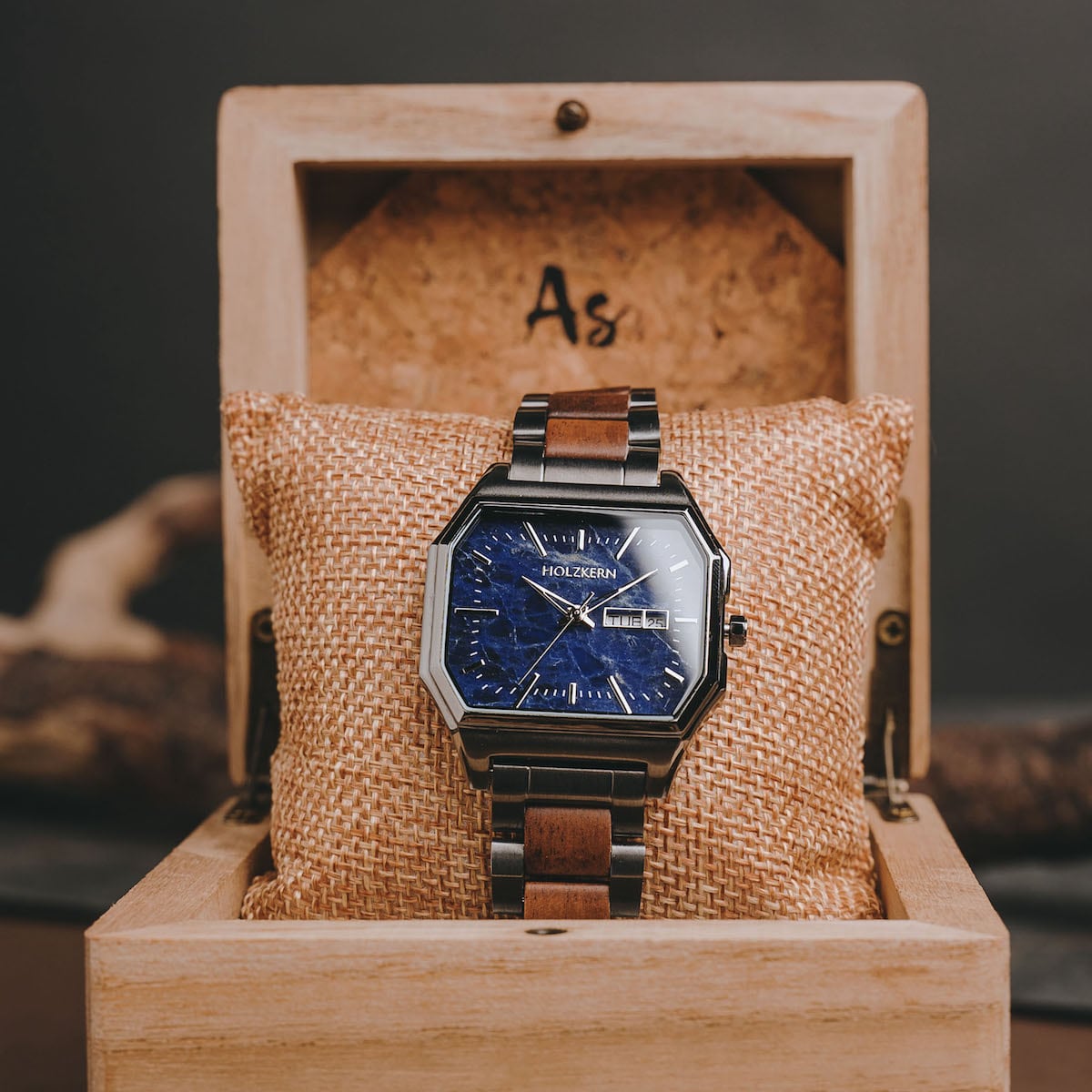 "Moneo" watch featuring a geometric face with koa and marble elements, styled in a rustic wooden box.