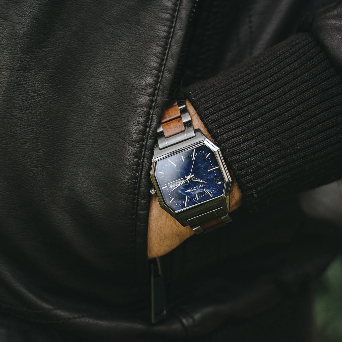 "Moneo" watch with elegant Koa and Marble materials, featuring a sleek, modern design on a wrist.