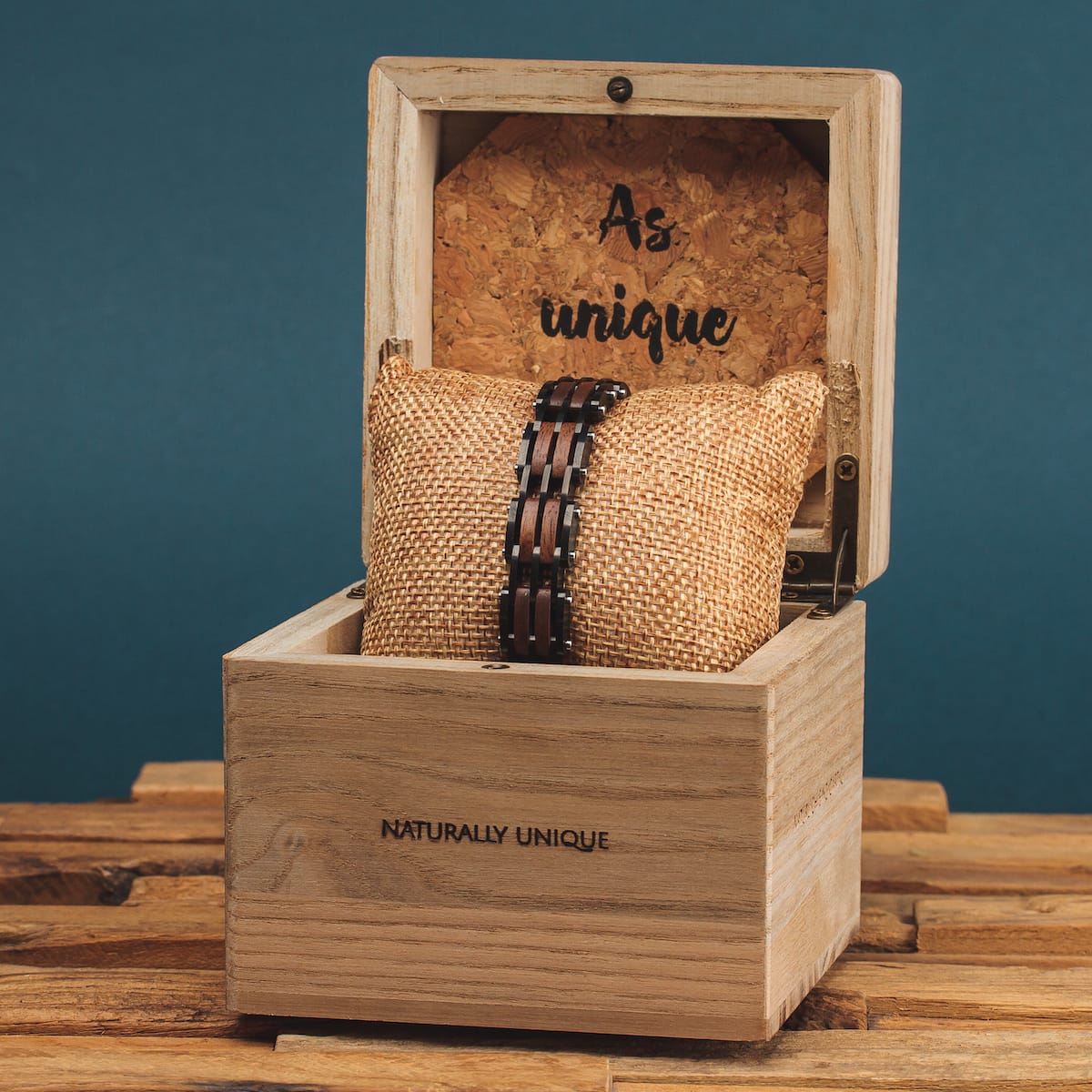 "Adagio" watch, featuring Walnut and gray tones, displayed in a rustic wooden box.