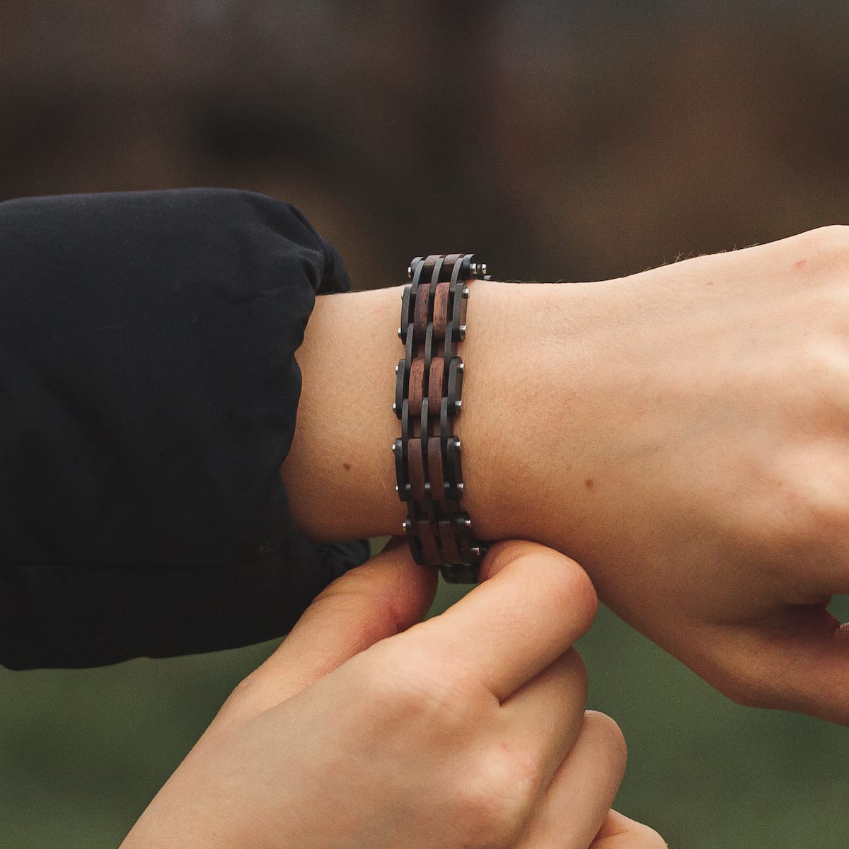 "Adagio" bracelet featuring a walnut and gray design on a wrist.