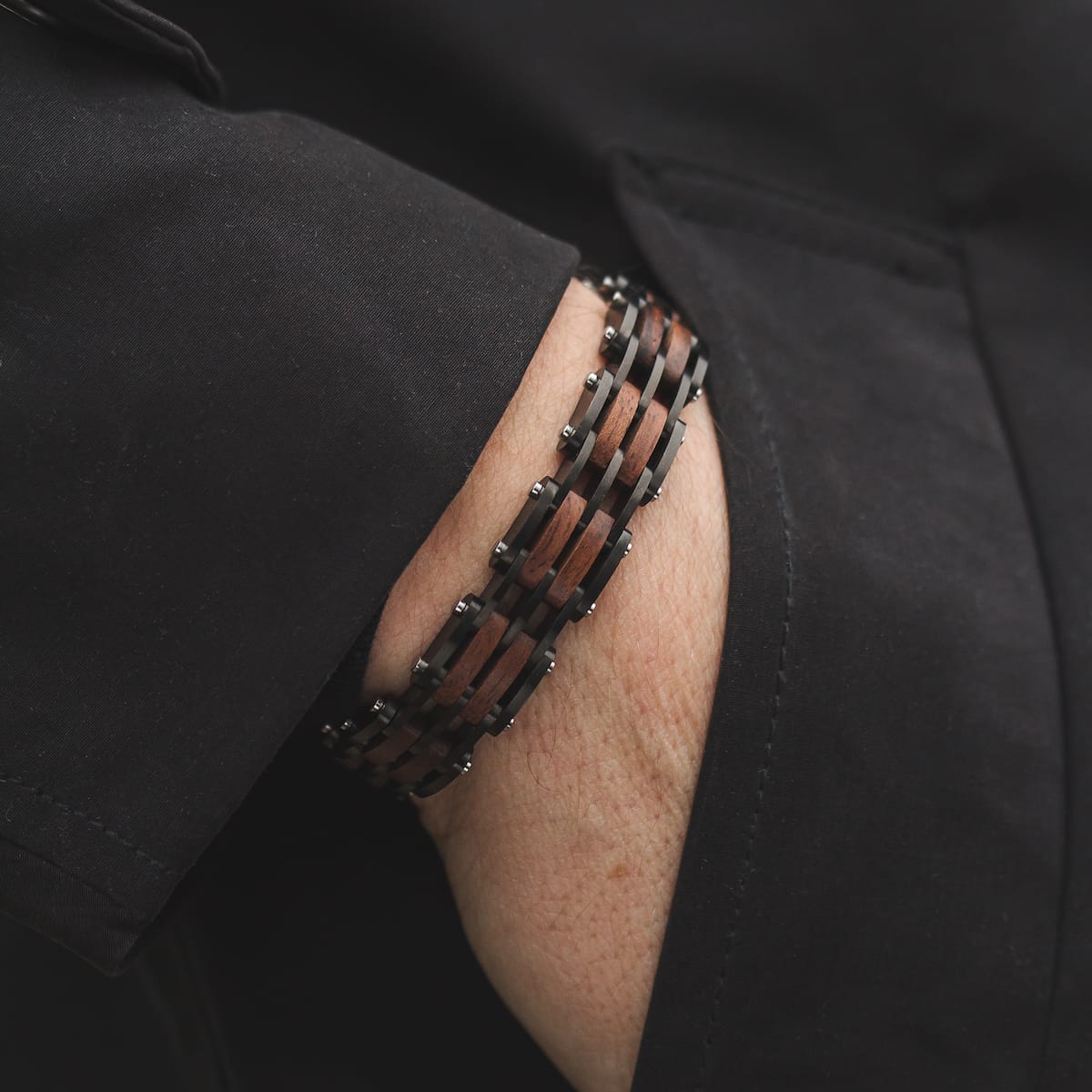 "Adagio", a stylish bracelet with a walnut and gray finish, elegantly worn.