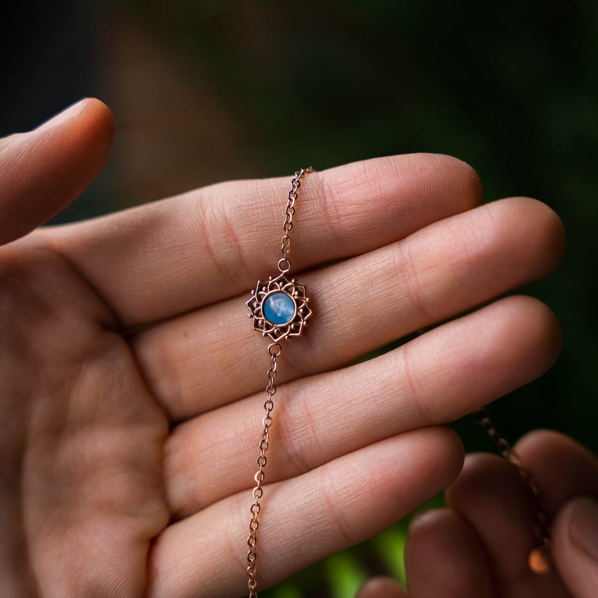 "Composition Bracelet", a delicate bracelet with blue nacre and rose gold accents, showcasing intricate design work.
