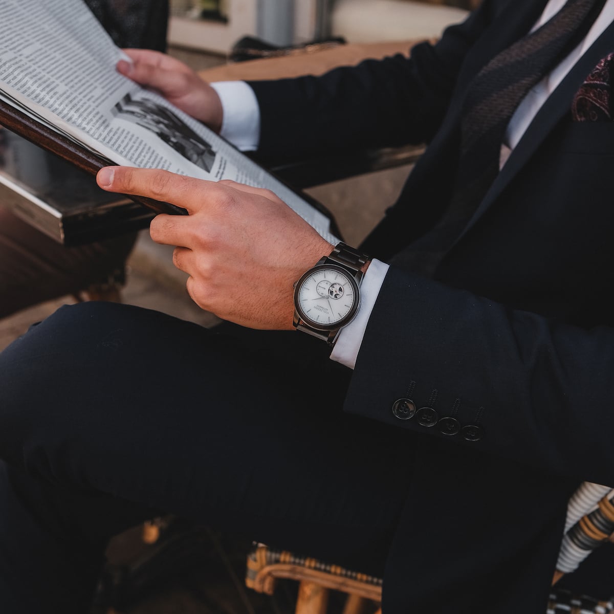 "Manhattan" wristwatch, featuring a sophisticated maple and marble design, worn with a formal suit.