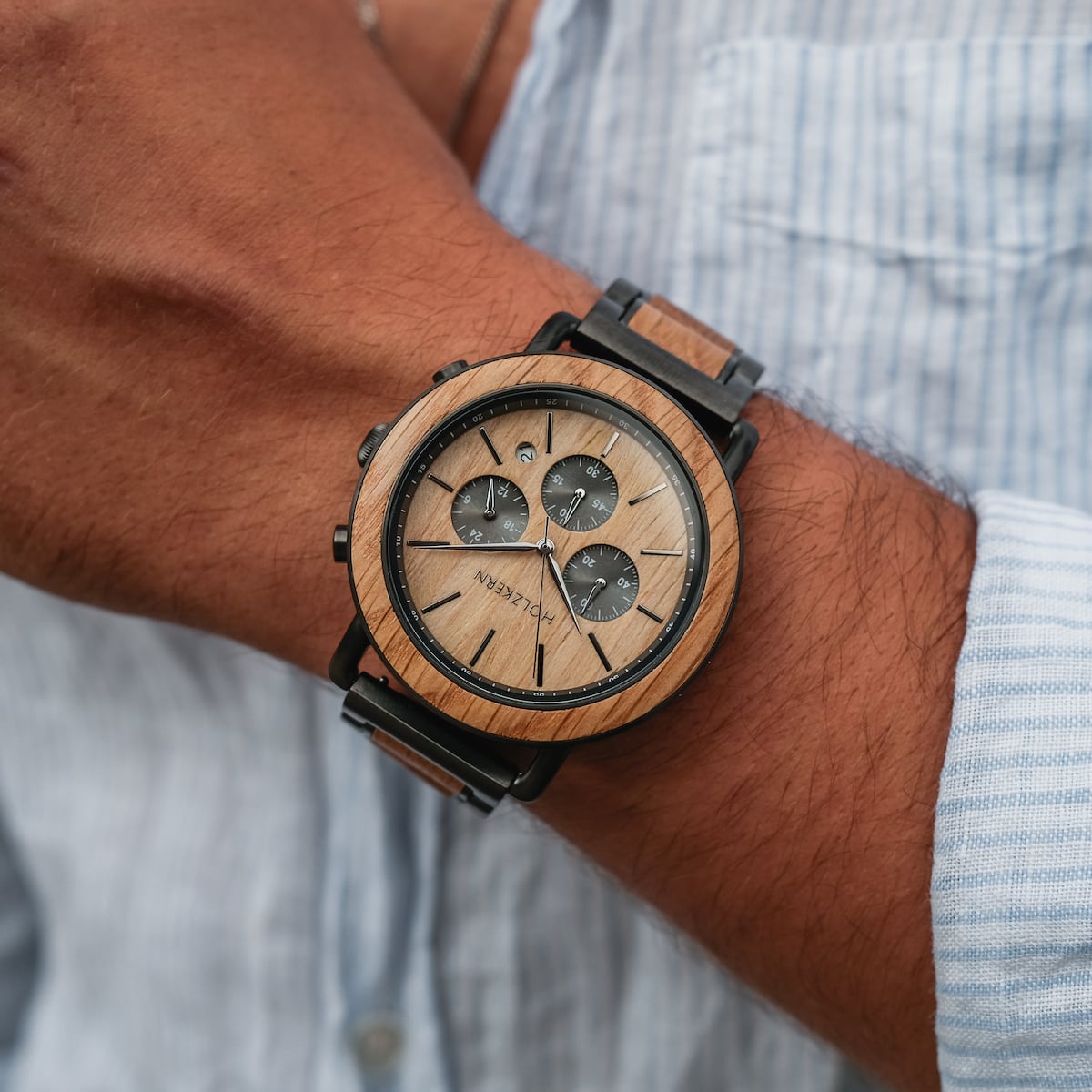 Whakaari elegant wristwatch with oak finish and chronograph design on a wrist.