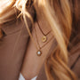 Stencil Necklace, a stylish gold and koa wood necklace with intricate circular designs.