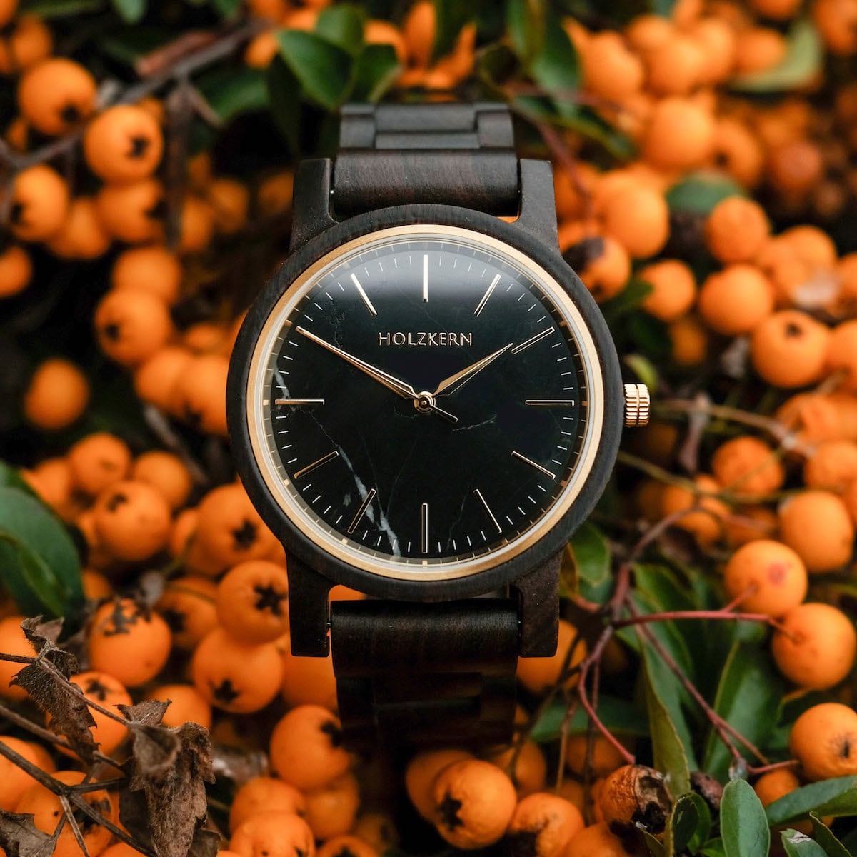 "Summer Night" watch featuring a sleek black face and maple band set against a backdrop of vibrant orange berries.