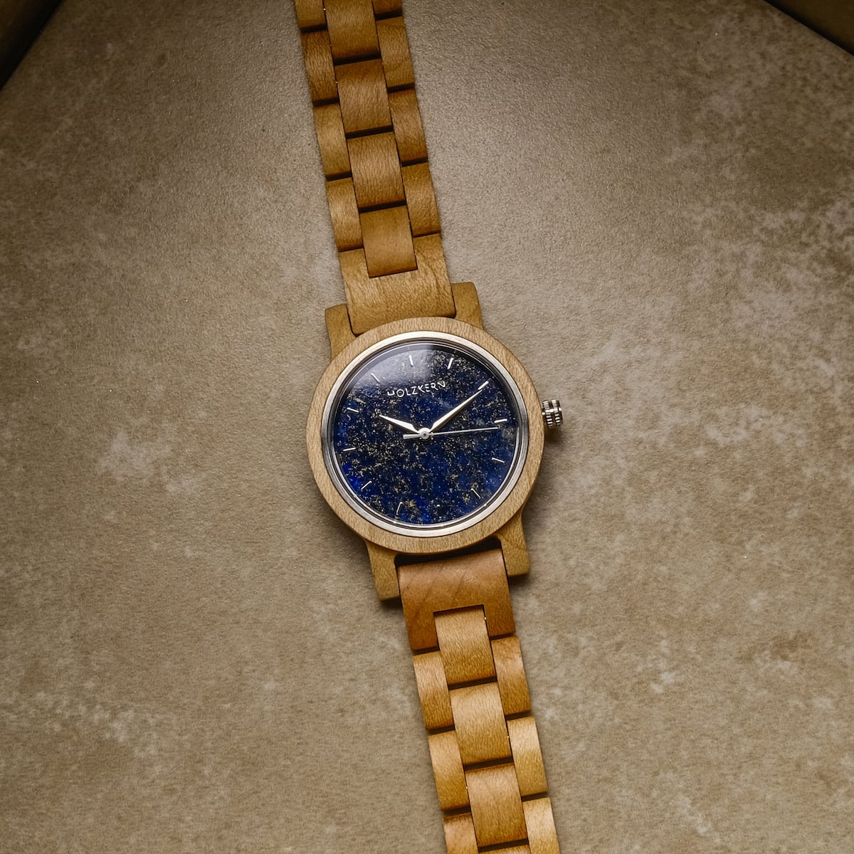 "Water" wooden watch with a striking lapis lazuli dial on a warm brown band.
