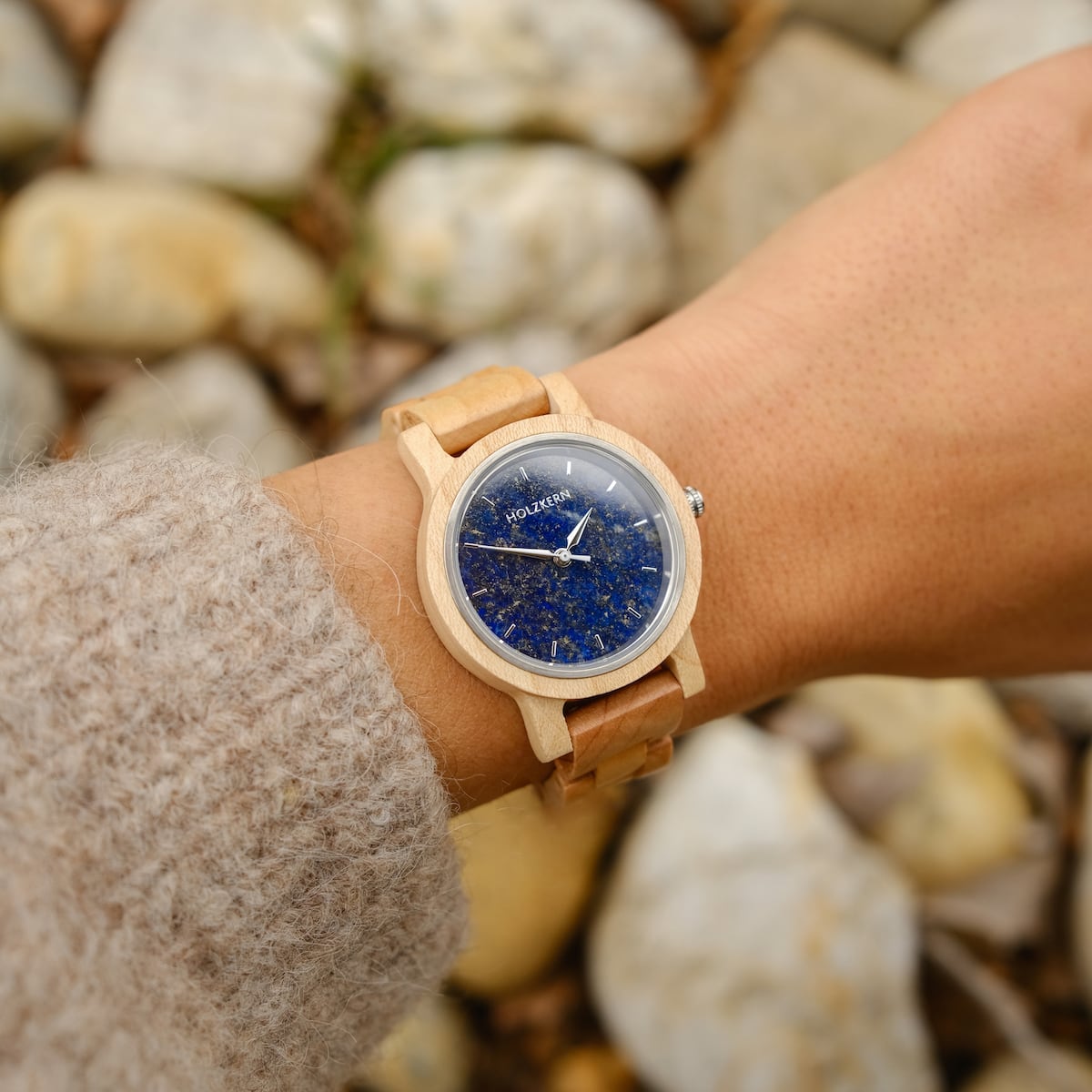 "Water" watch with maple and lapis lazuli design on wrist, blending natural elegance and vibrant blue hues.