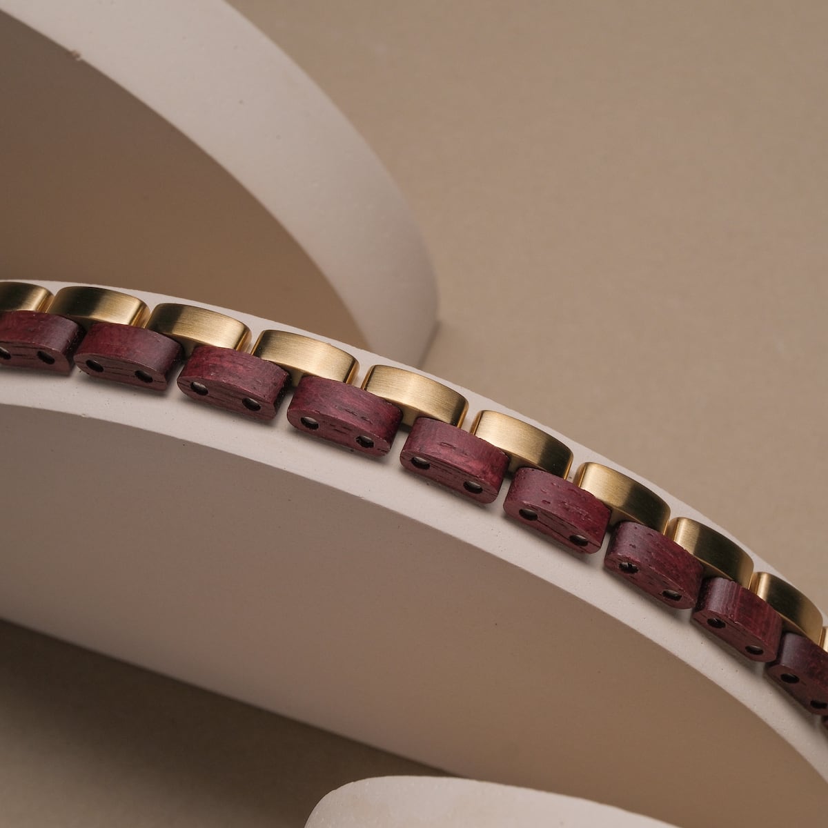 "Duet", a stylish bracelet featuring amaranth and gold tones with a modern, geometric design.