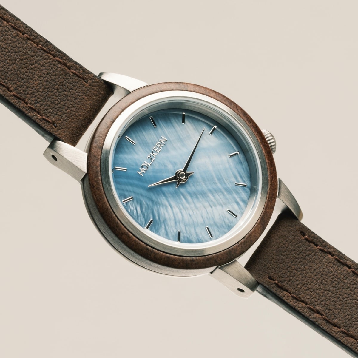 "Côte d'Azur" watch featuring a walnut and nacre design with a classic, elegant style.
