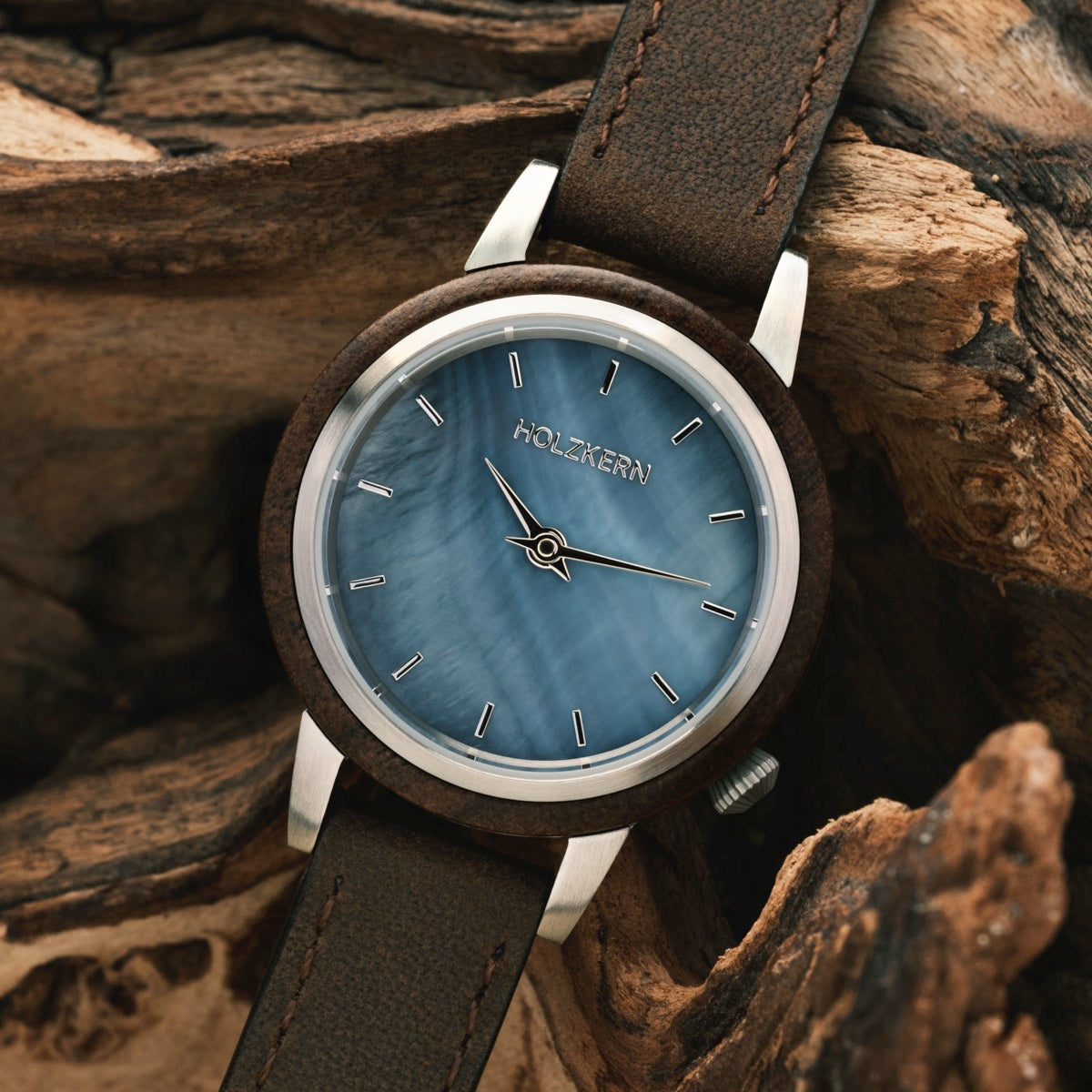 "Côte d'Azur" watch with walnut casing and nacre dial, rustic and elegant aesthetic.