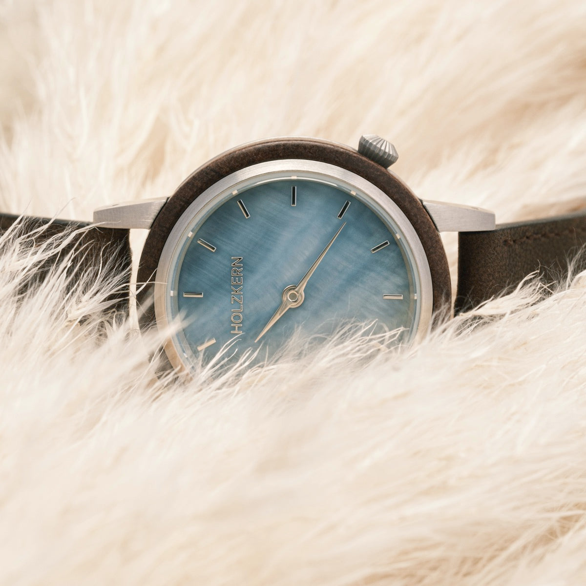 "Côte d'Azur" watch featuring a blue nacre dial and walnut accents, embodying elegant craftsmanship.