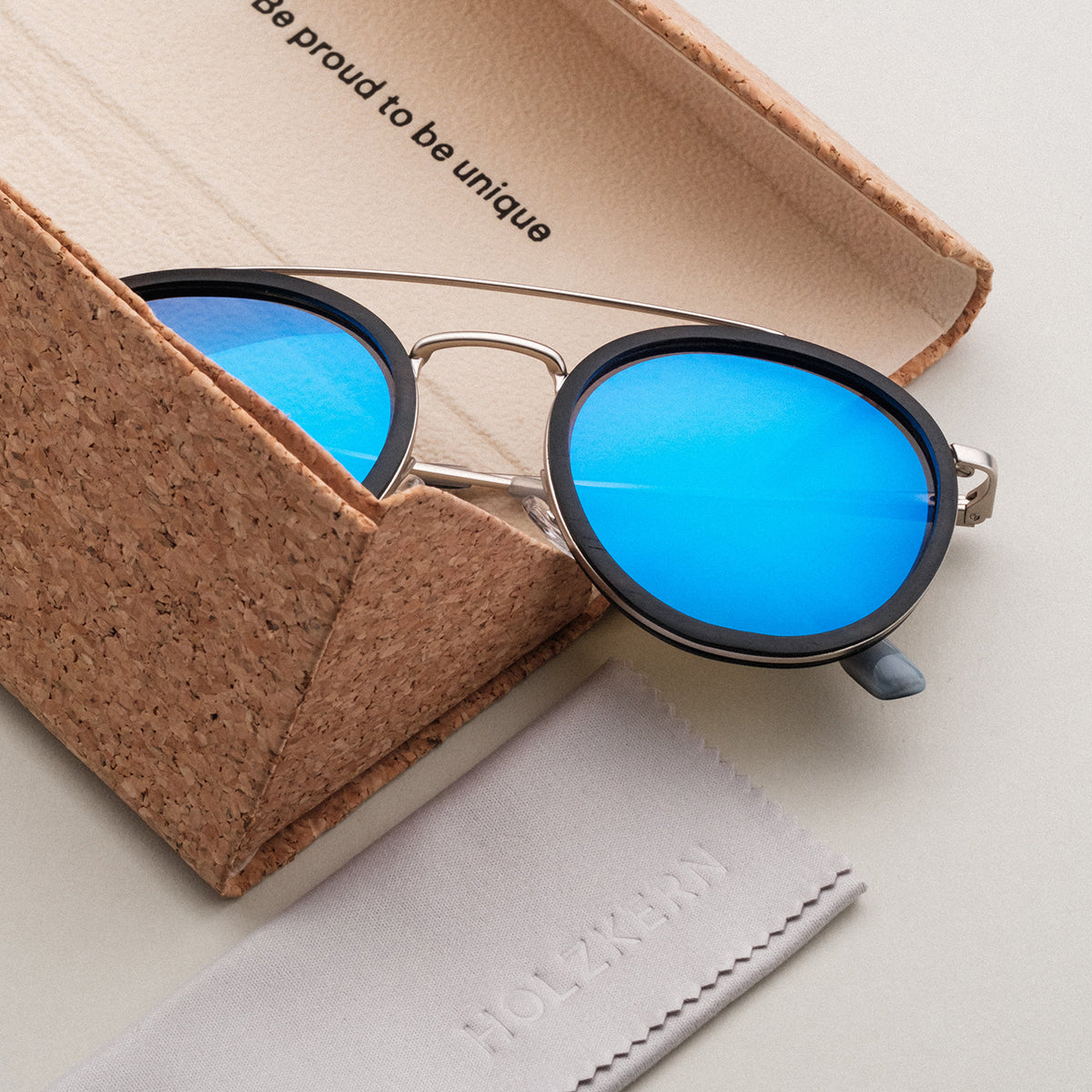 "The Enchanting" sunglasses featuring a stylish design with blue lenses and antique silver frames.